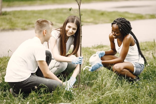 Team building écologique : un groupe de collaborateurs plante un jeune arbre dans un parc